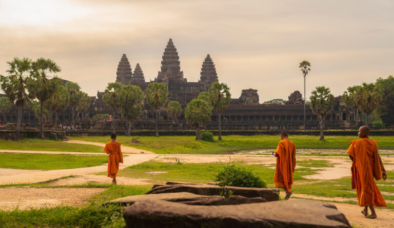 Angkor Wat Temple at sunrise with monks