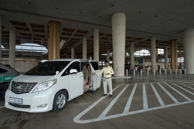 driver at phnom penh airport with toyota alphard vehicle at arrivals area