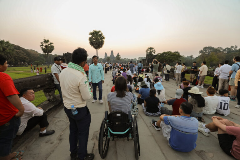 Wheelchair user watching Angkor Wat sunrise equinox in Siem Reap