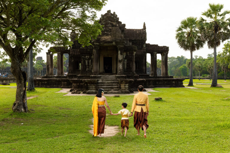 Family wearing traditional Khmer clothing near the Southern Library at Angkor Wat, Cambodia