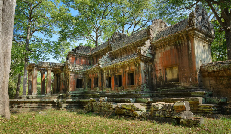 The ancient east library structure of Angkor Wat framed by green trees near the eastern rear entrance