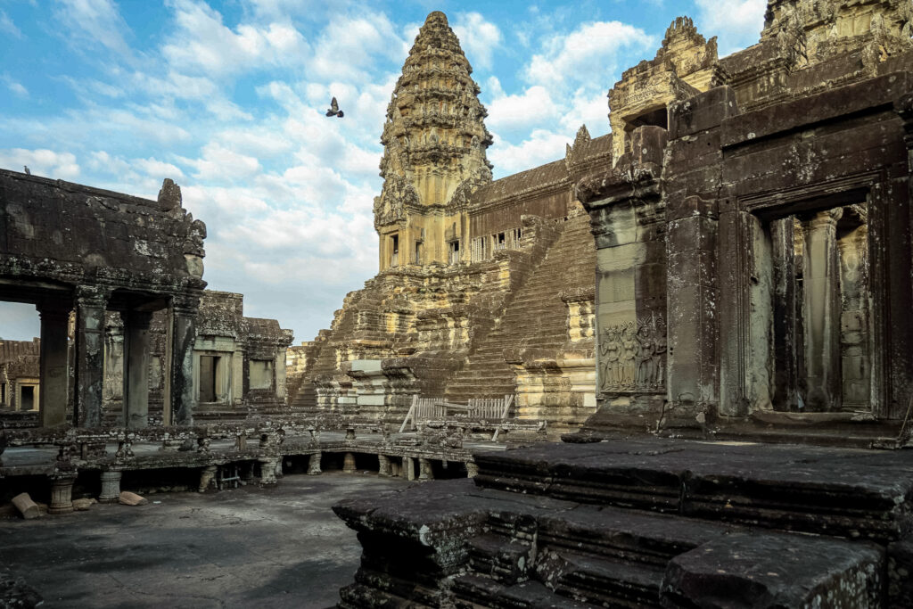 View looking up at the central lotus tower and upper tier of Angkor Wat from the courtyard below
