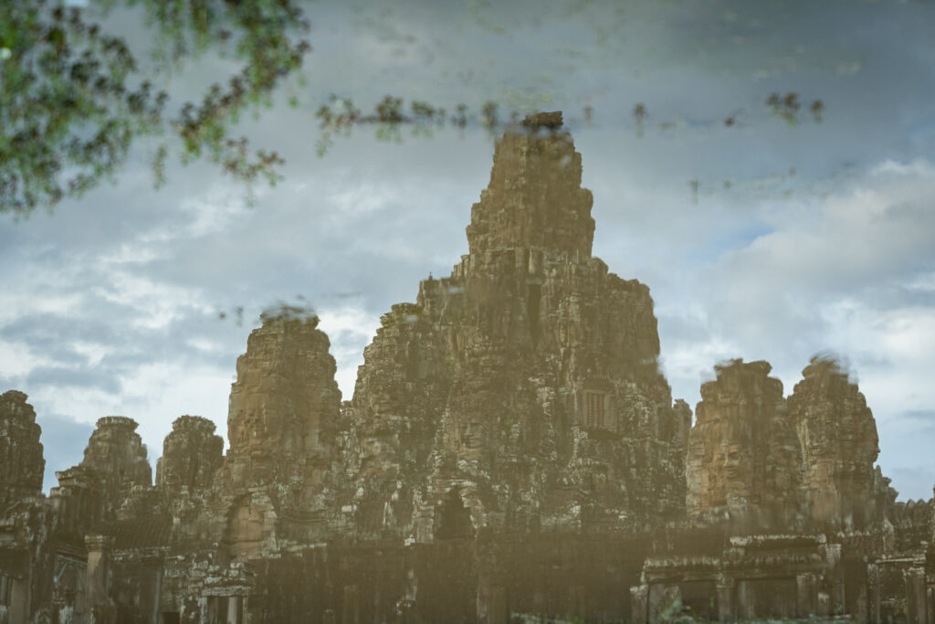 Bayon reflected in a puddle