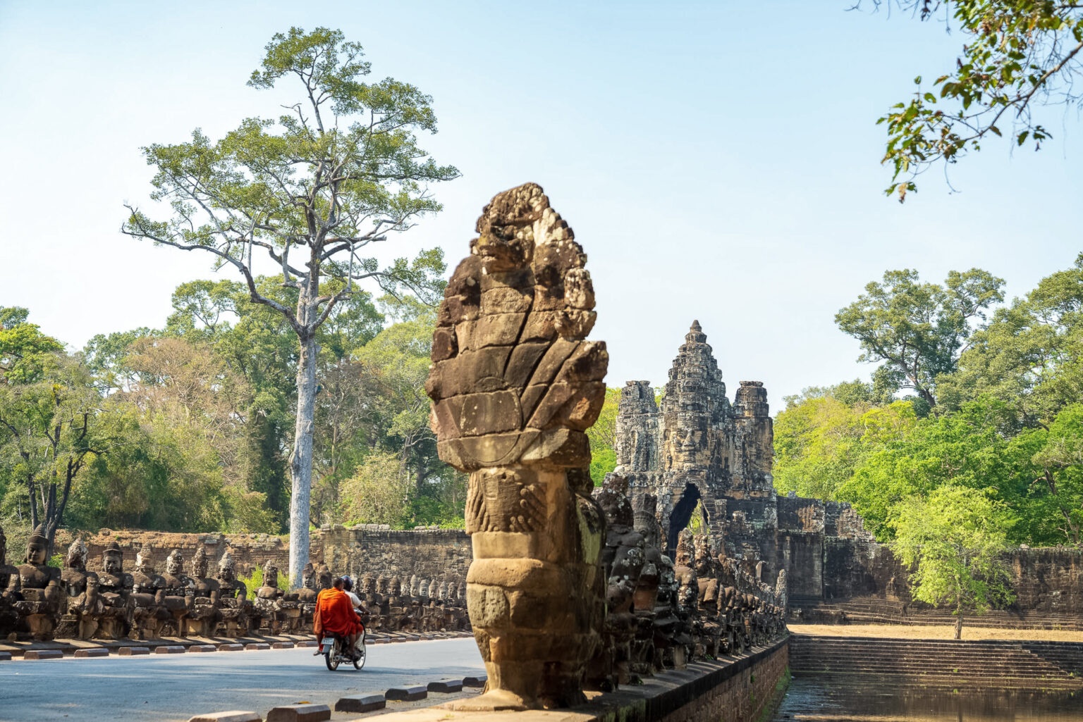 South Gate of Angkor Thom with stone naga balustrade and face tower, Angkor Archaeological Park, Cambodia
