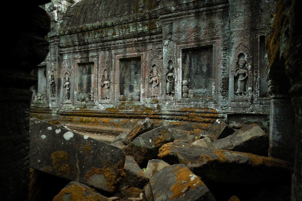 Weathered stone walls and ruins in a collapsed gallery at Ta Prohm