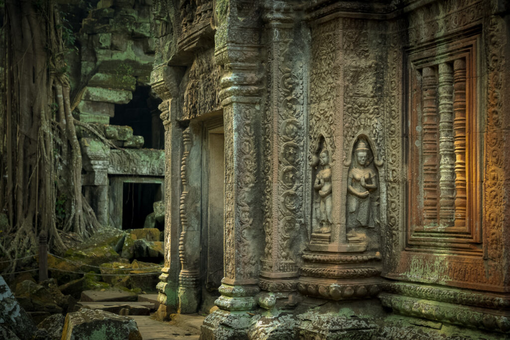 Detailed stone carvings in an inner courtyard are of the ancient ruins of Ta Prohm temple