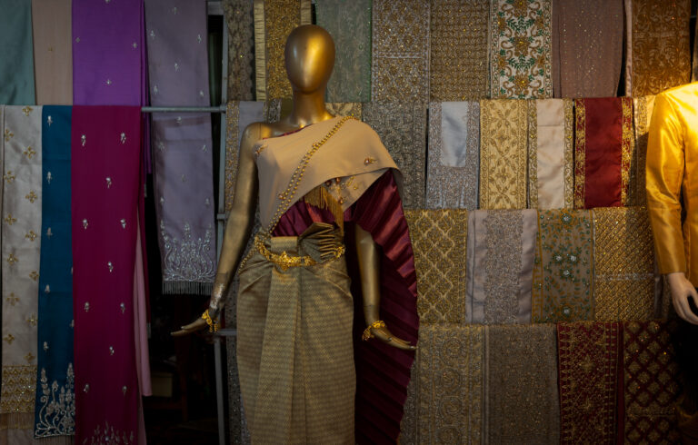 Mannequin wearing a traditional Khmer silk dress and gold jewelry inside a rental shop near Siem Reap