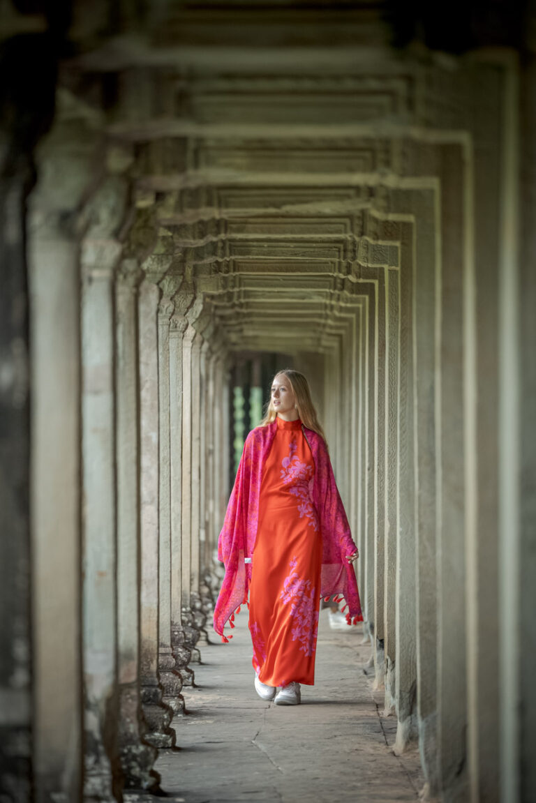 woman walking in corridor of Angkor wat