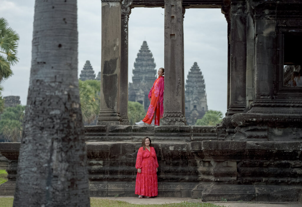 lady in red dress in front of angkor wat on a photoshoot