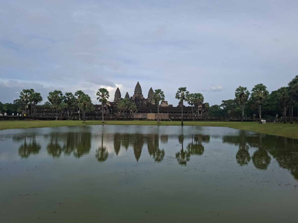 Southern reflecting pool at Angkor Wat with temporary bamboo structure affecting the temple view