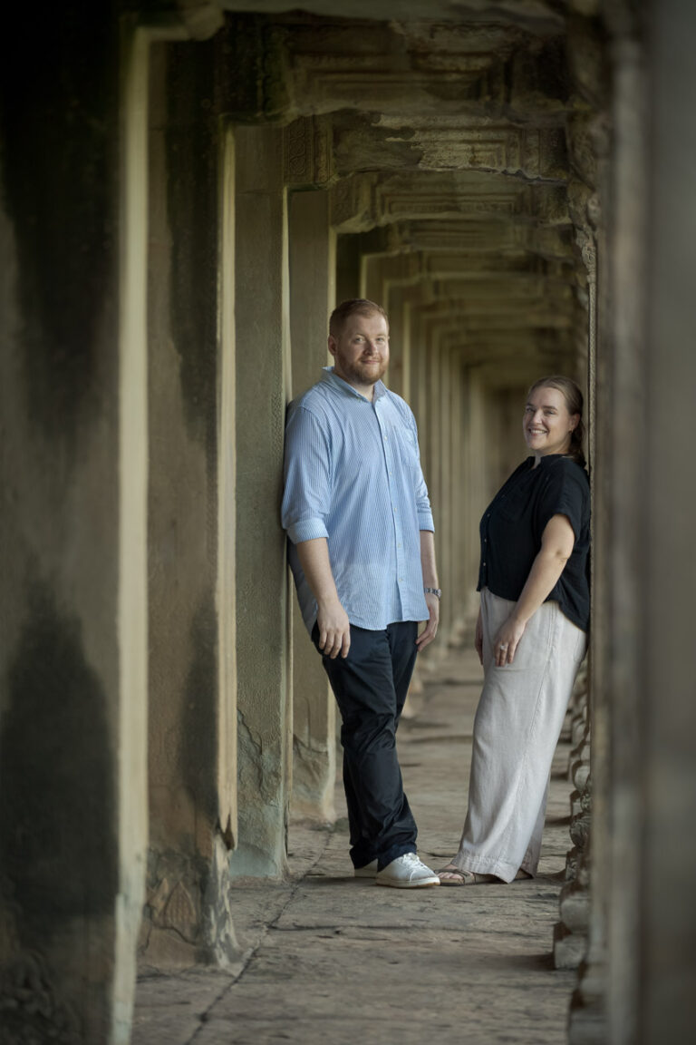 Couple posing together in a temple corridor at Angkor Wat