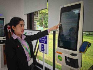 Angkor Parvis staff demonstrating the ticket machine.